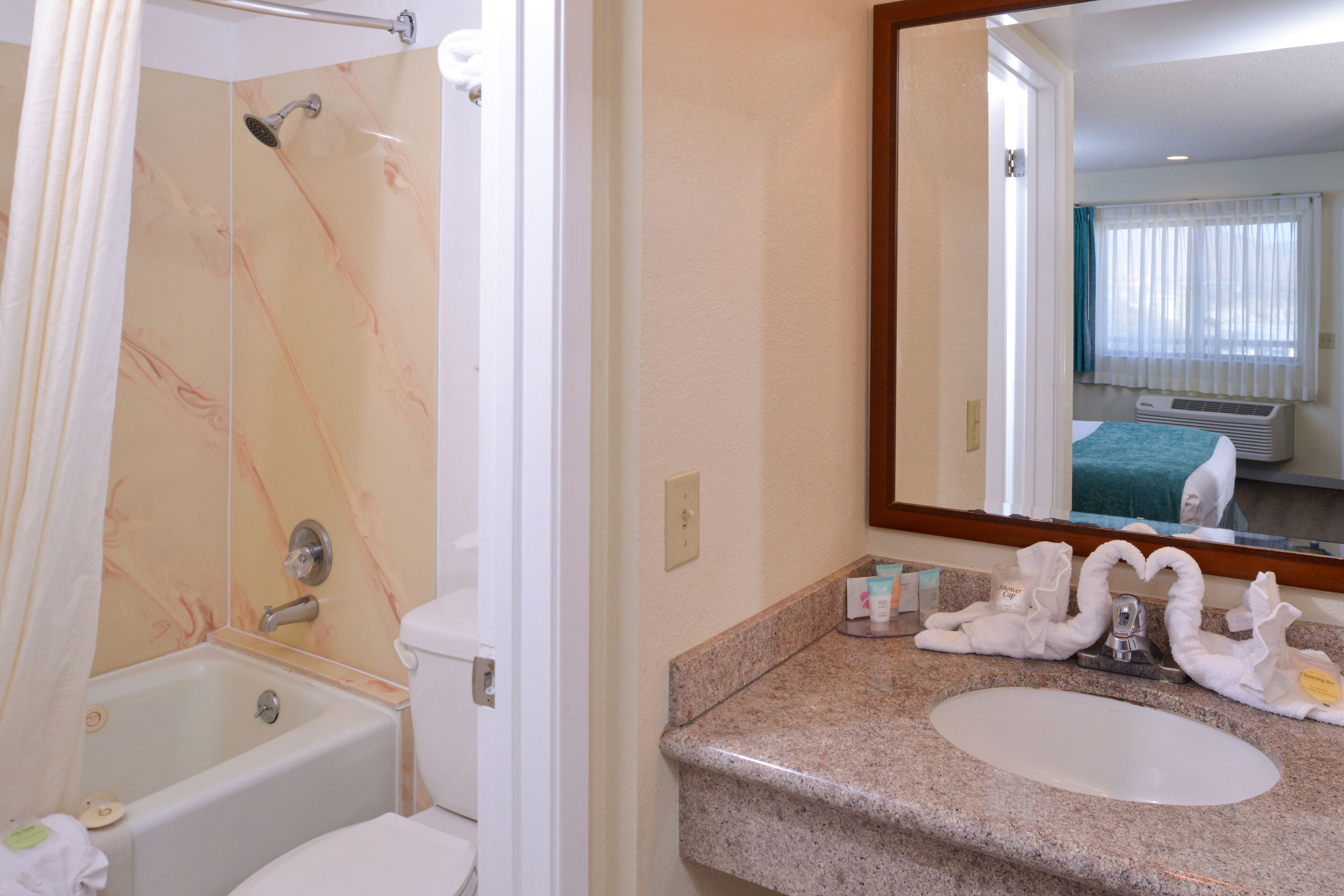 A bathroom with a bathtub, toilet, and sink.