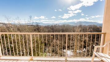 A balcony with a view of a mountainous landscape.