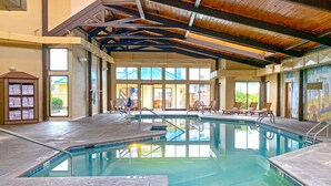 An indoor swimming pool with clear water, tiled floors, and a wooden ceiling. - Music Road Resort Hotel and Inn (Pigeon Forge)
