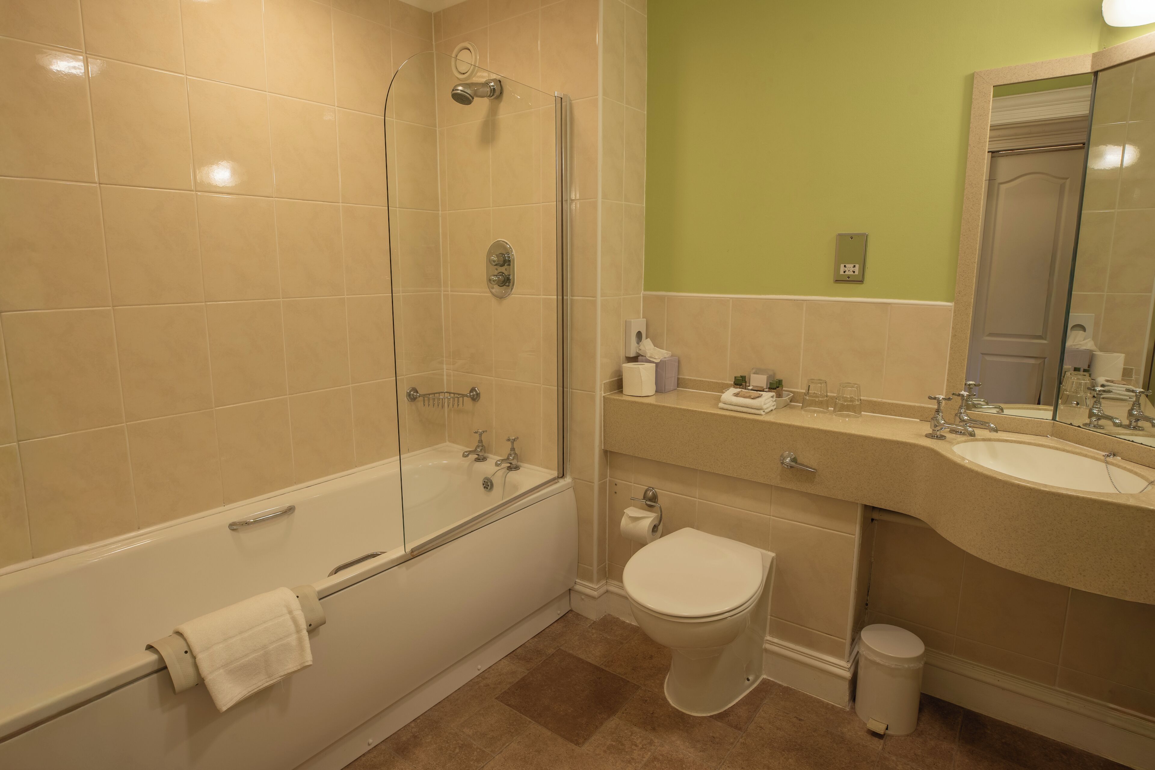 A bathroom with a bathtub, toilet, and sink.