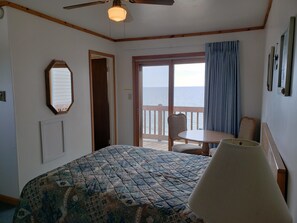 Relax in this serene retreat with a large bed and a balcony offering a view of the sea.