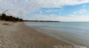 Enjoy a serene beach experience with a gentle slope into the calm waters.