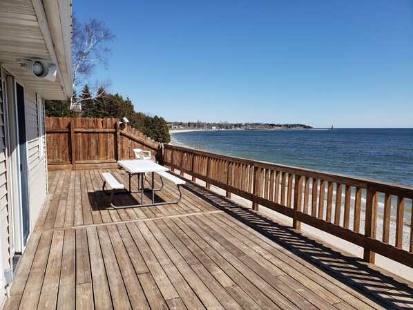 Enjoy outdoor dining or relaxation on this deck overlooking the water.