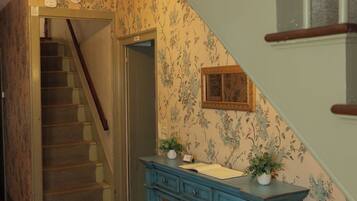 A staircase with wooden railings and a blue cabinet with drawers.