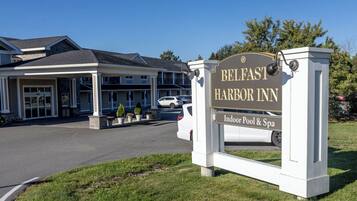 A sign for Belfast Harbor Inn with an indoor pool and spa.