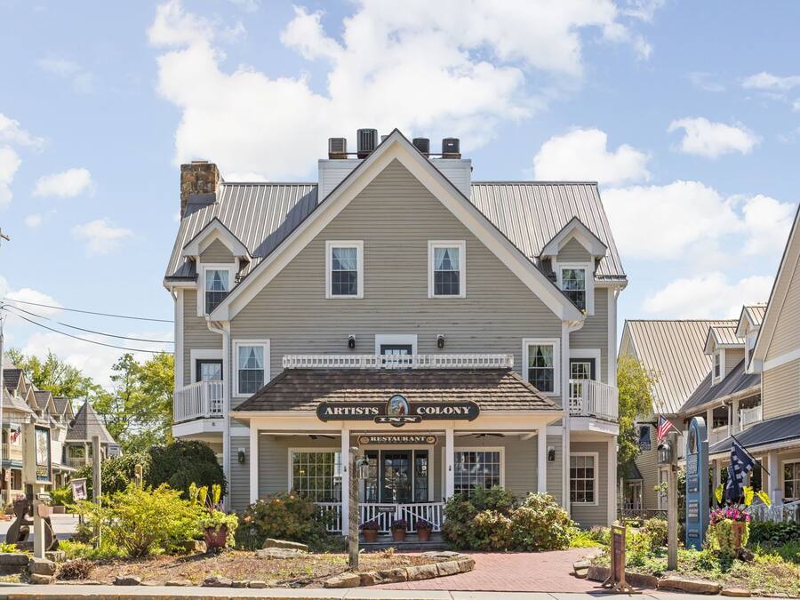 A two-story building with a sign reading "Artists' Colony Restaurant."
