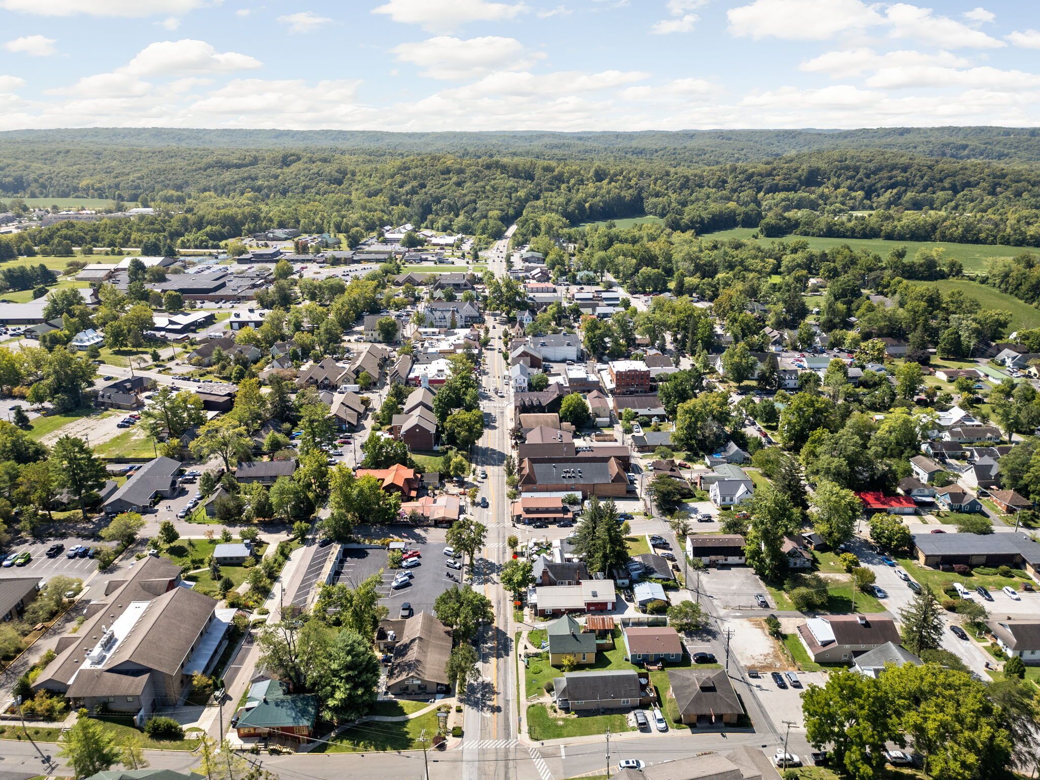 An aerial view of a residential area with houses, streets, and green spaces.