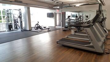 A gym with treadmills, a stationary bike, and weight machines.