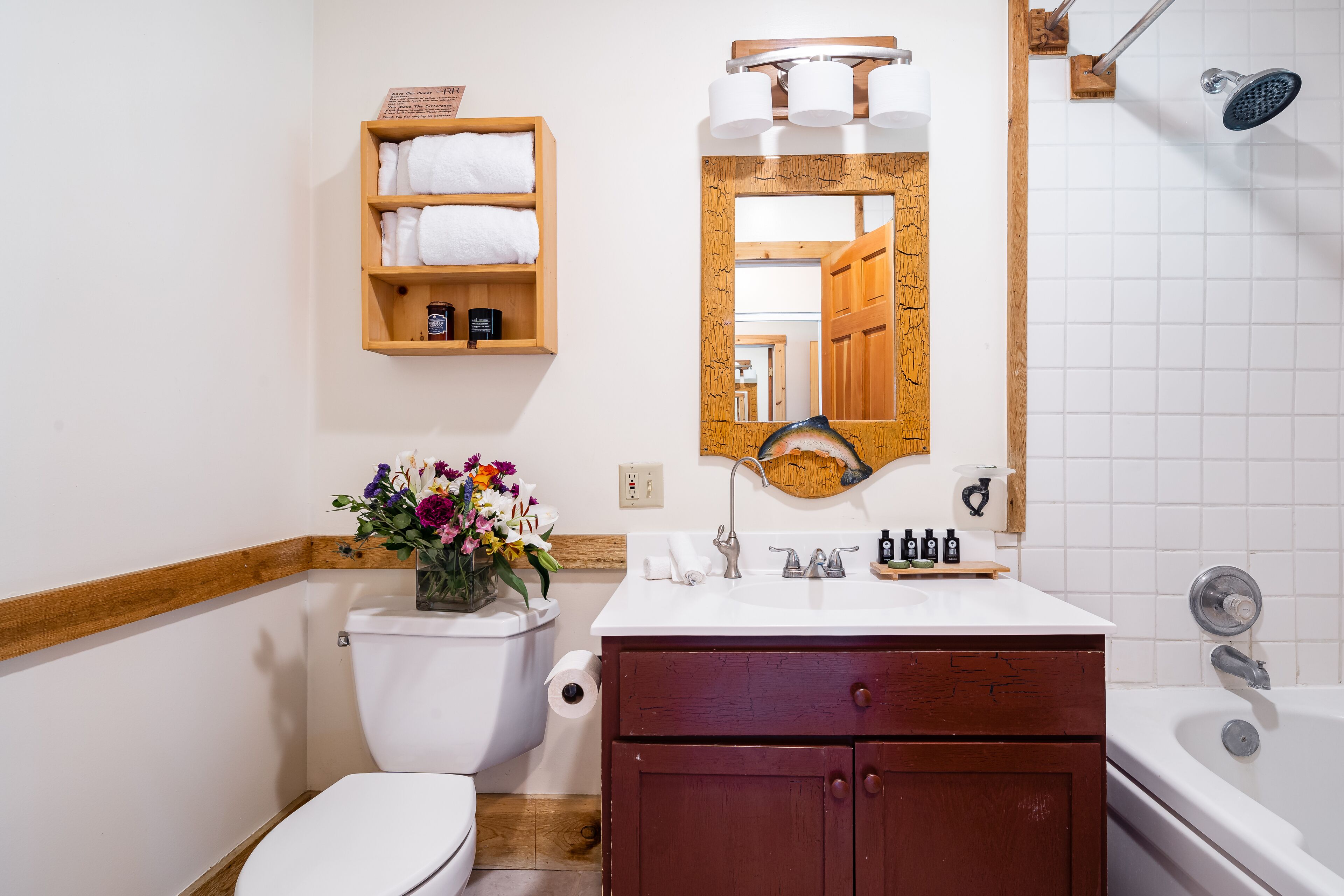 Ein Badezimmer mit Toilette, Waschbecken, Waschtisch und Badewanne.