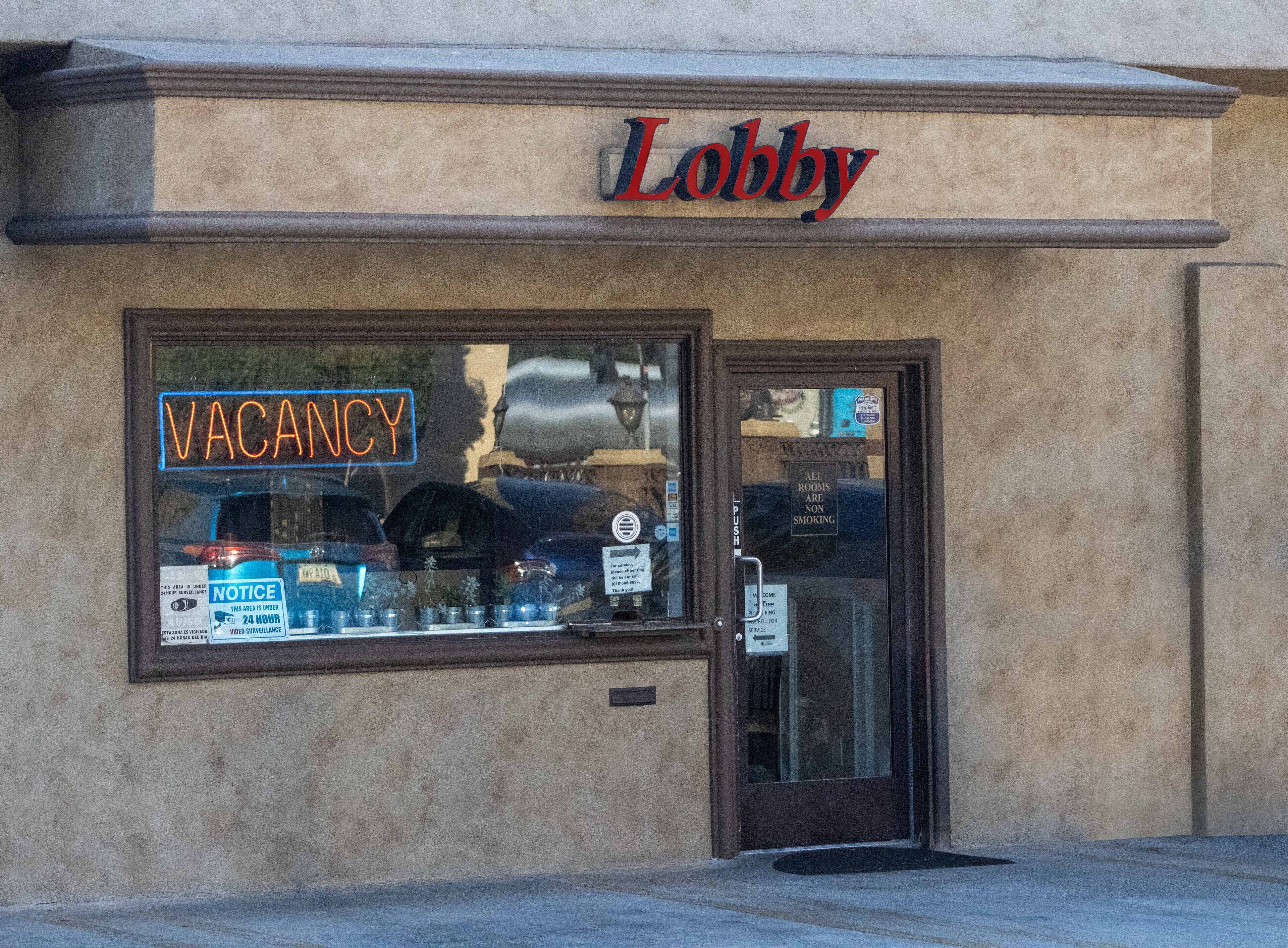 A building with a 'Lobby' sign above the entrance. A 'VACANCY' sign is visible in the window.