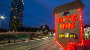 A building with a sign that reads "Nite Inn" and "Universal City" with a star emblem.