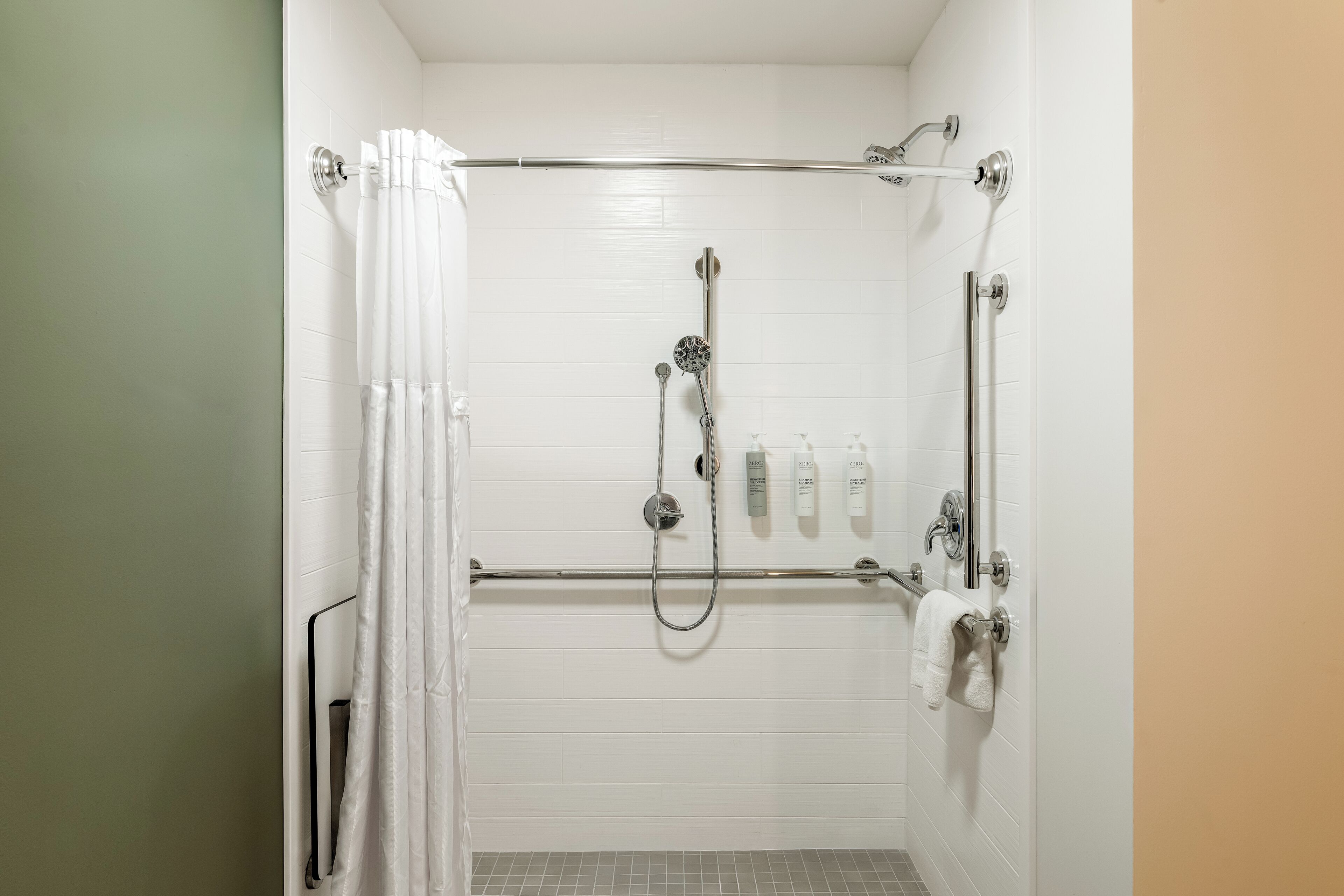 Room, 1 King Bed, Accessible (Mobility & Hearing, Roll-in Shower) | Bathroom | Combined shower/tub, free toiletries, hair dryer, towels