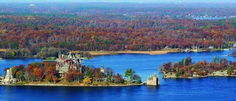 A large body of water with multiple islands, one featuring a prominent castle-like structure.