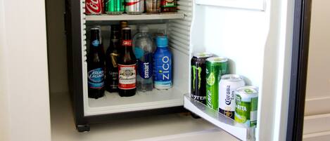 A refrigerator stocked with various beverages including Coca-Cola, Sprite, Diet Coke, Bud Light, Guinness, Smart, ZICO, Monster, Corona, and Margarita.