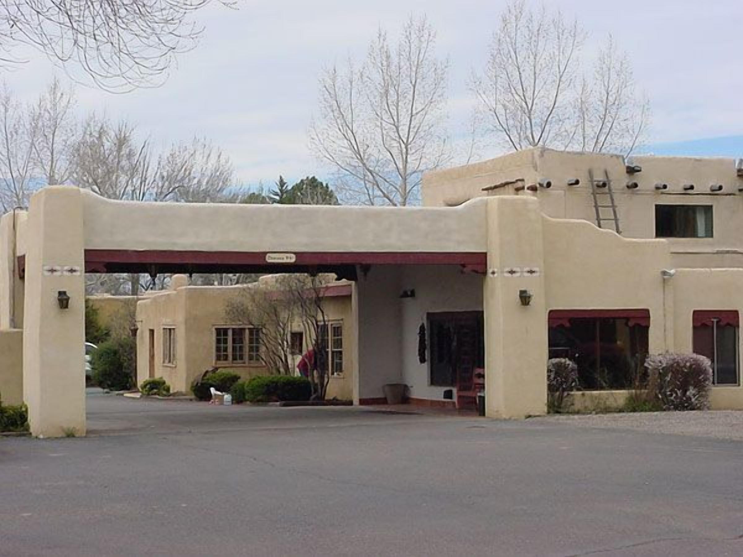 A building with a flat roof, a covered entrance, and a sign that reads "Dunmore Rd."