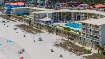 On the beach, white sand, beach cabanas, sun loungers