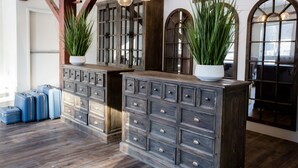 A room with wooden cabinets, potted plants, and hanging light fixtures.