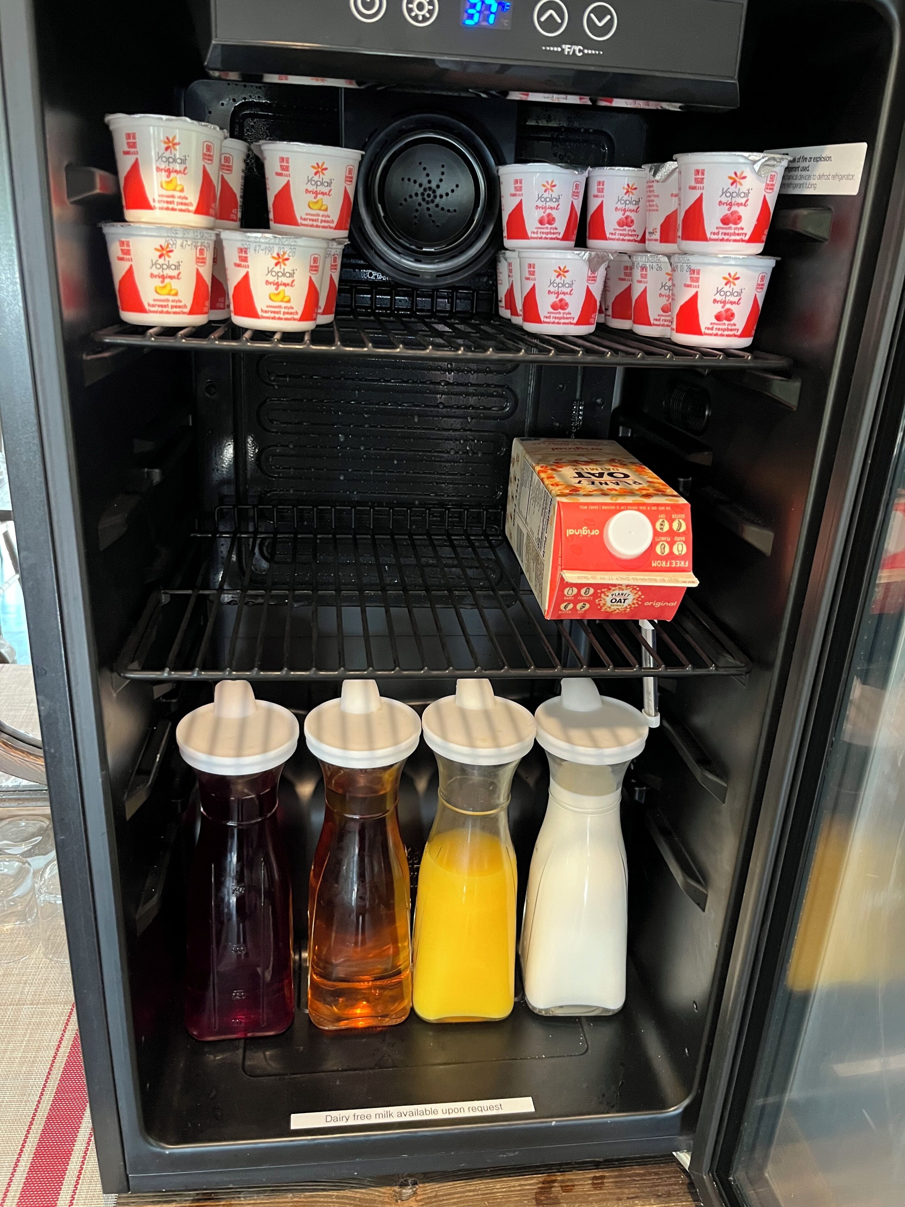 A refrigerator stocked with various dairy products including yogurts and milk.