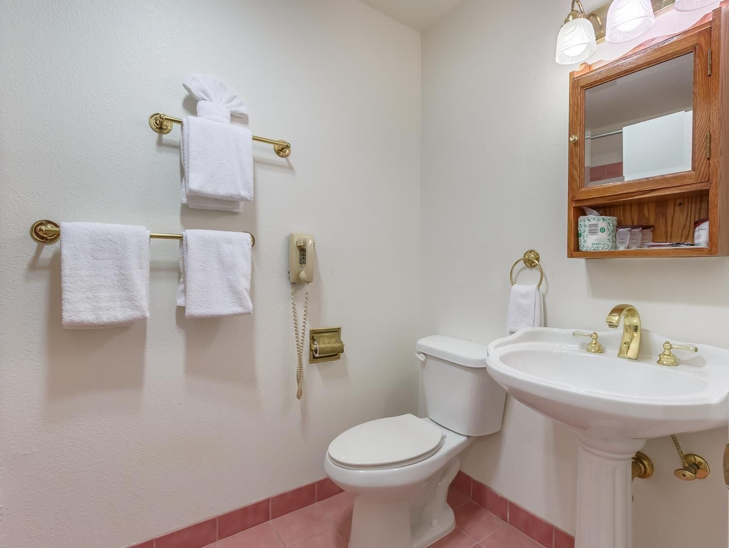 A bathroom with a toilet, sink, and towel rack.