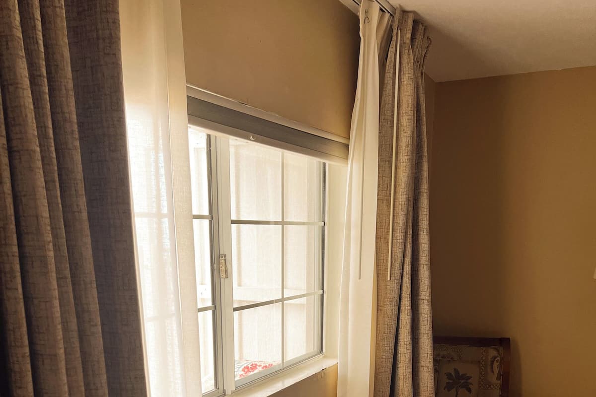 A room with a window, a chair, and a small table.