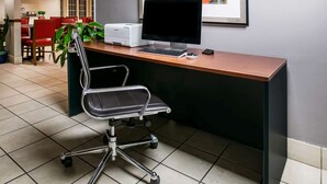 A modern office desk with a computer, keyboard, and mouse.