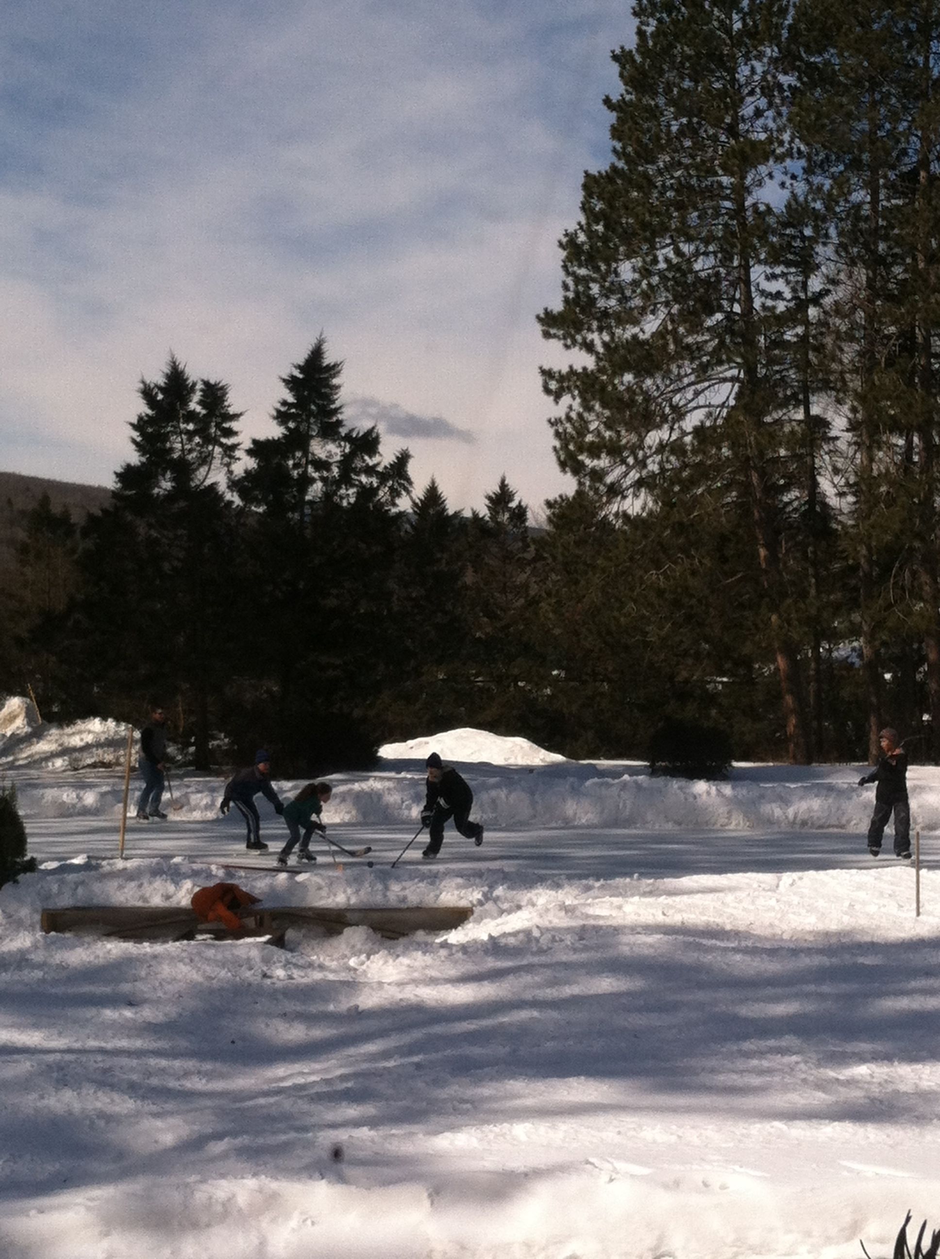 A snowy outdoor area with people skiing.