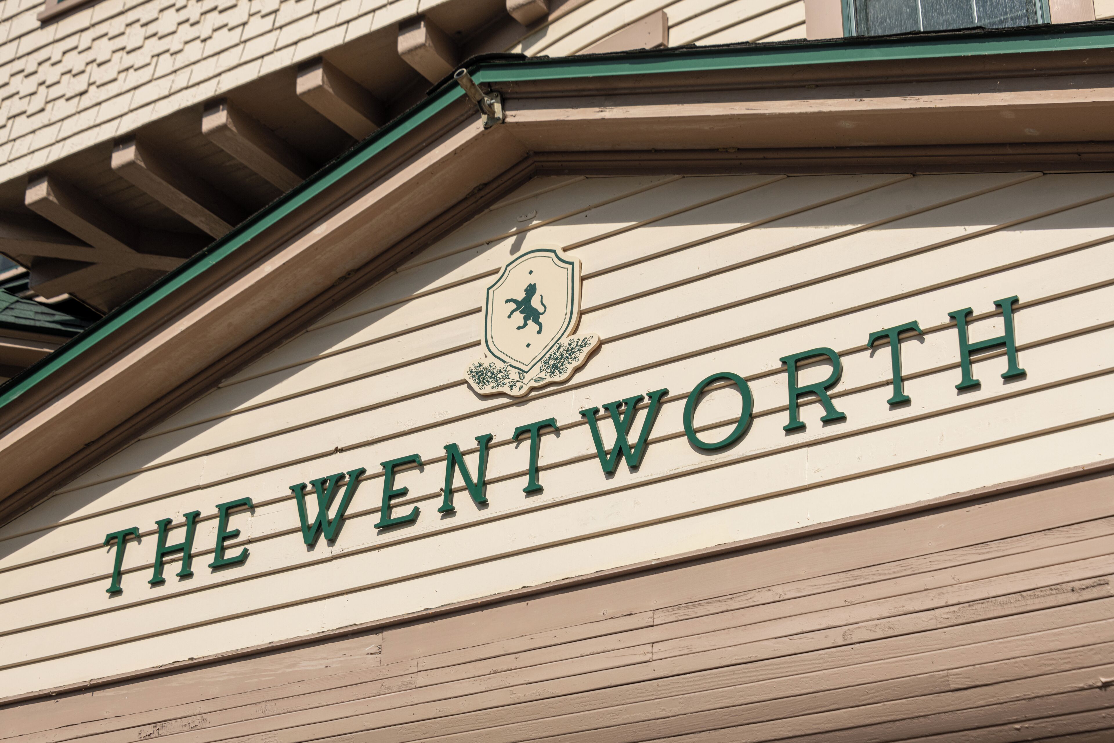 A building sign with the name "THE WENTWORTH" and a crest above it.