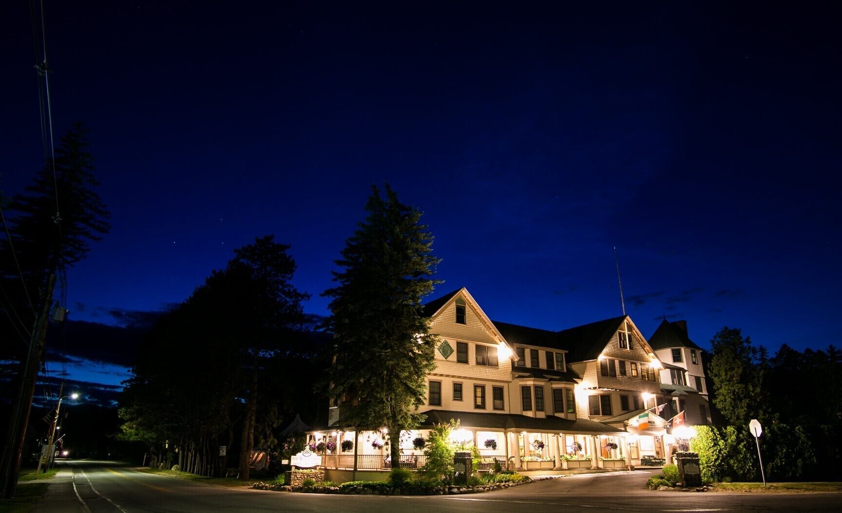 A large, multi-story building with a prominent entrance and a well-lit facade.