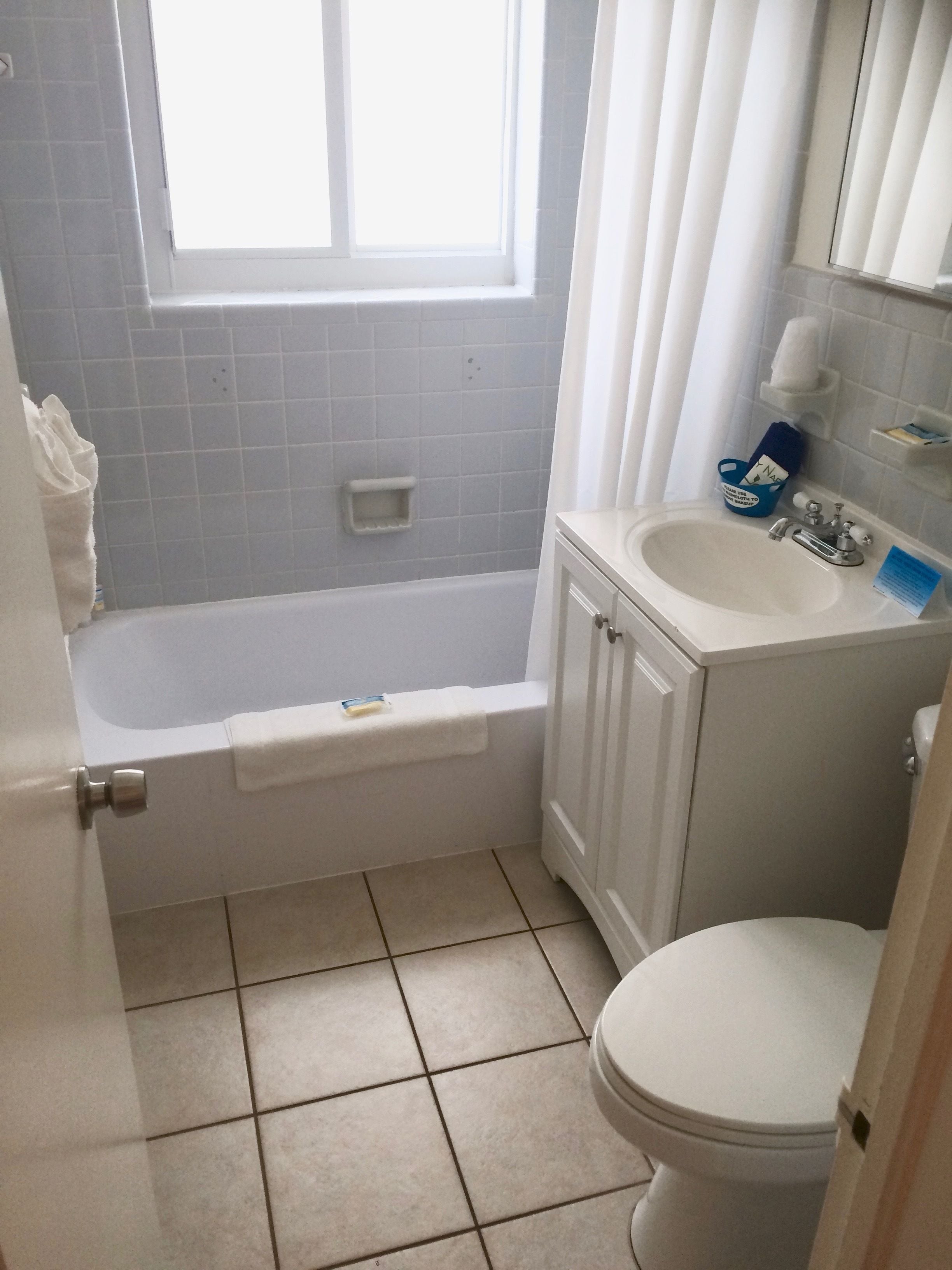 A bathroom with a bathtub, a sink, and a toilet.