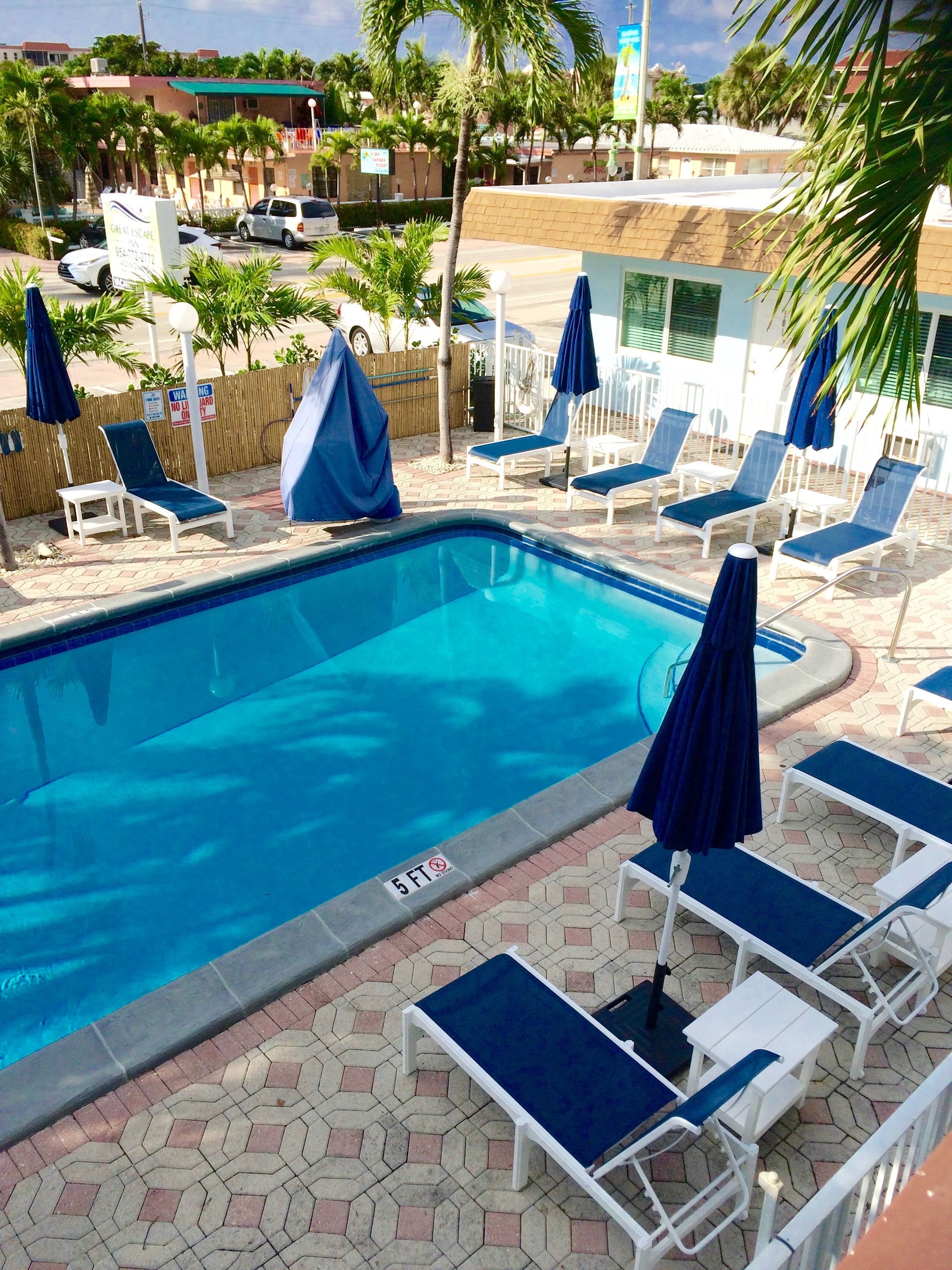 outdoor pool, pool umbrellas, pool loungers
