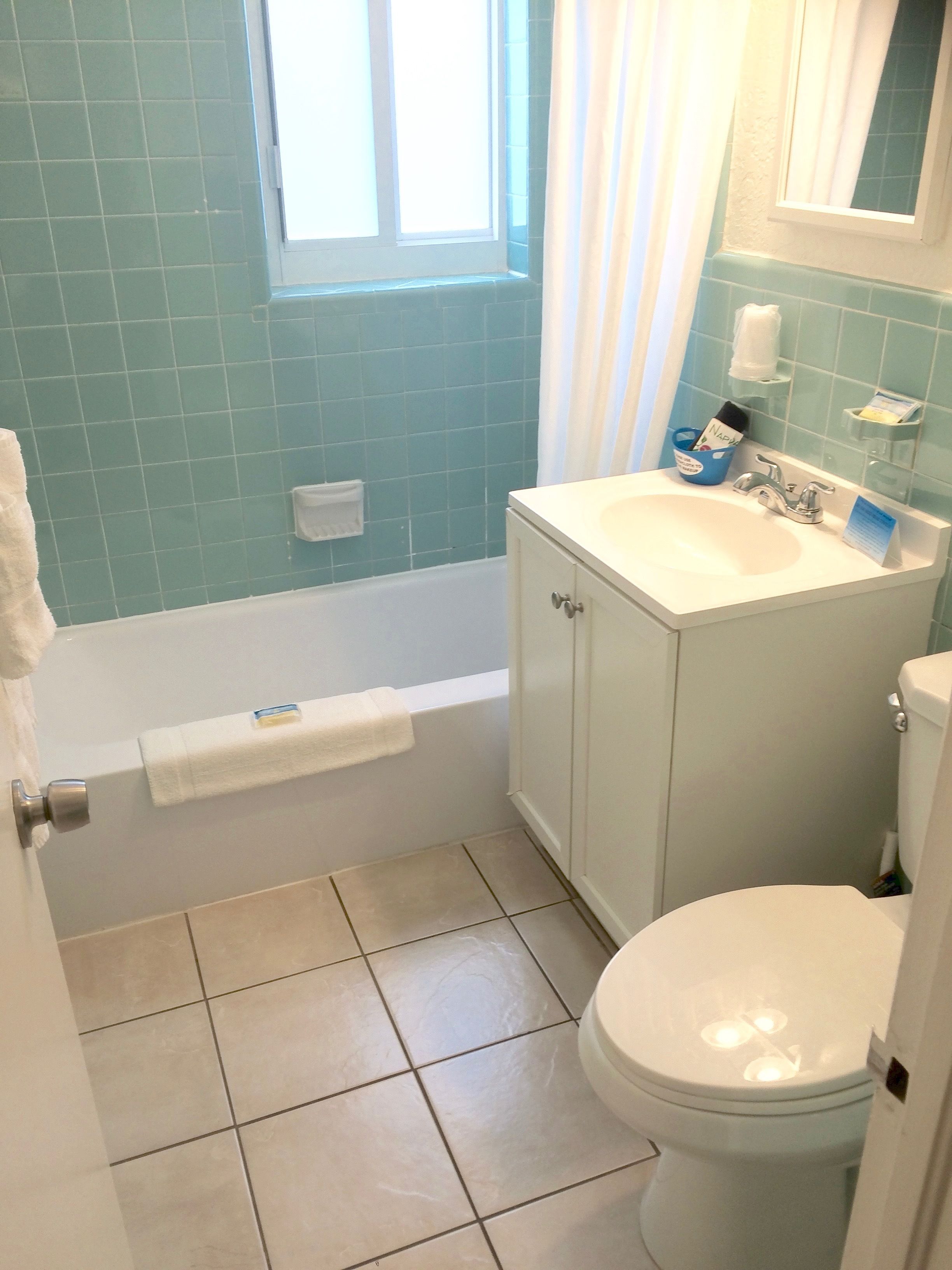A bathroom with a bathtub, a sink, and a toilet.
