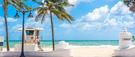 Beach nearby, white sand, beach umbrellas, beach towels