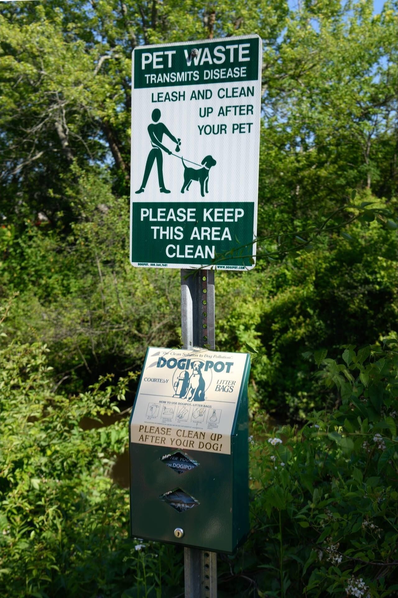 A sign instructing to leash and clean up after pets to prevent disease transmission.