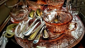 A tray with a copper-colored glass cup and silverware.