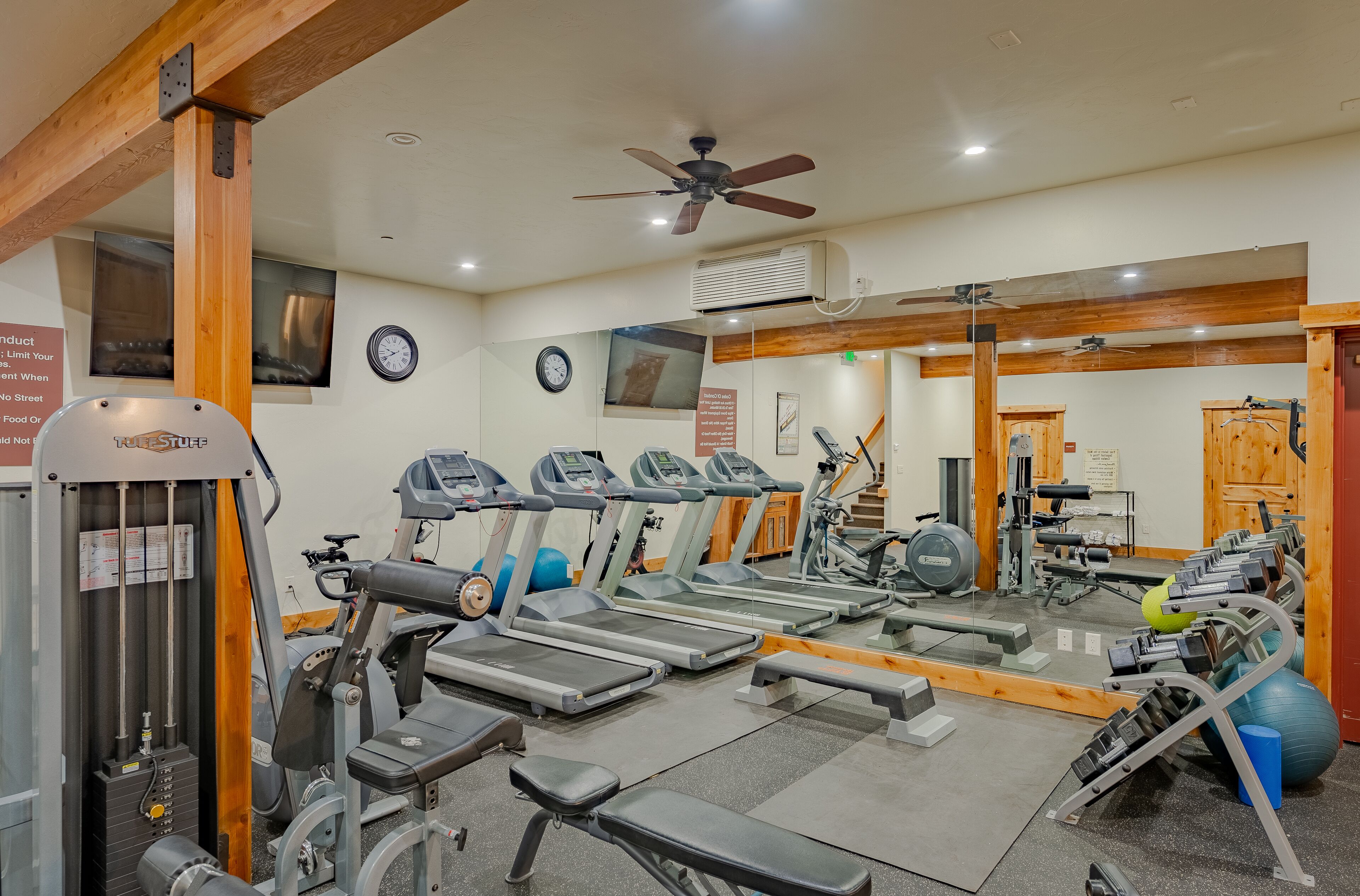 A gym with treadmills, exercise bikes, and weight machines.