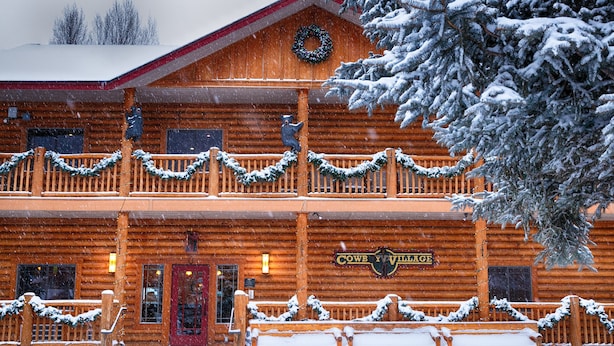 A log cabin with a sign reading "Cowb Y VillagE". - Cowboy Village Resort (Jackson)