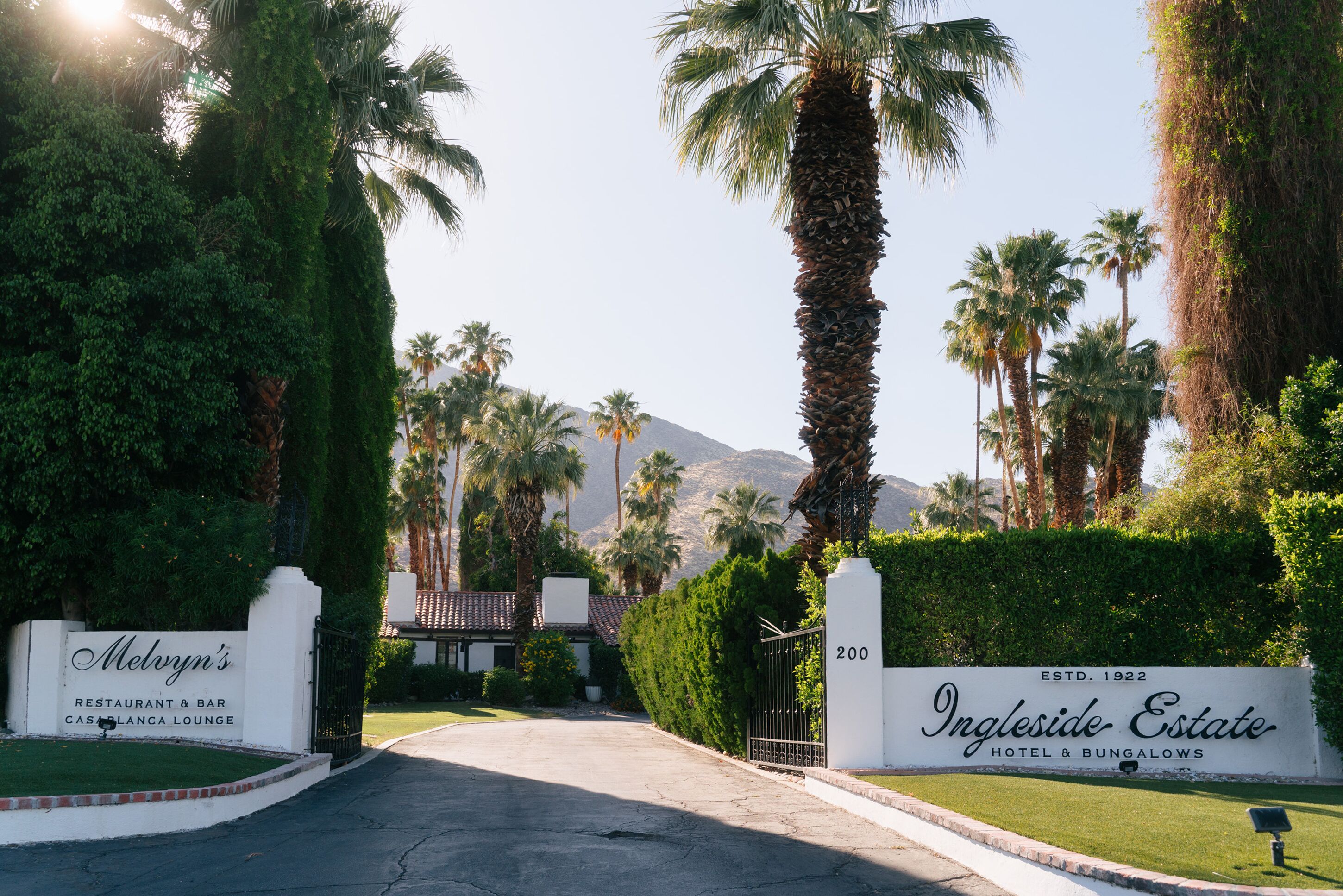 A gated entrance to Ingleside Estate Hotel & Bungalows with a sign indicating the address and establishment year.