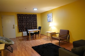 Family Suite, Non Smoking | Living area | 32-inch LED TV with cable channels, TV
