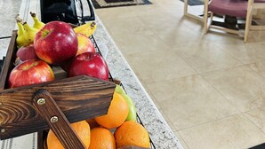 A fruit display with apples, bananas, and oranges in a hotel lobby. - Timberland Inn & Suites (Castle Rock)