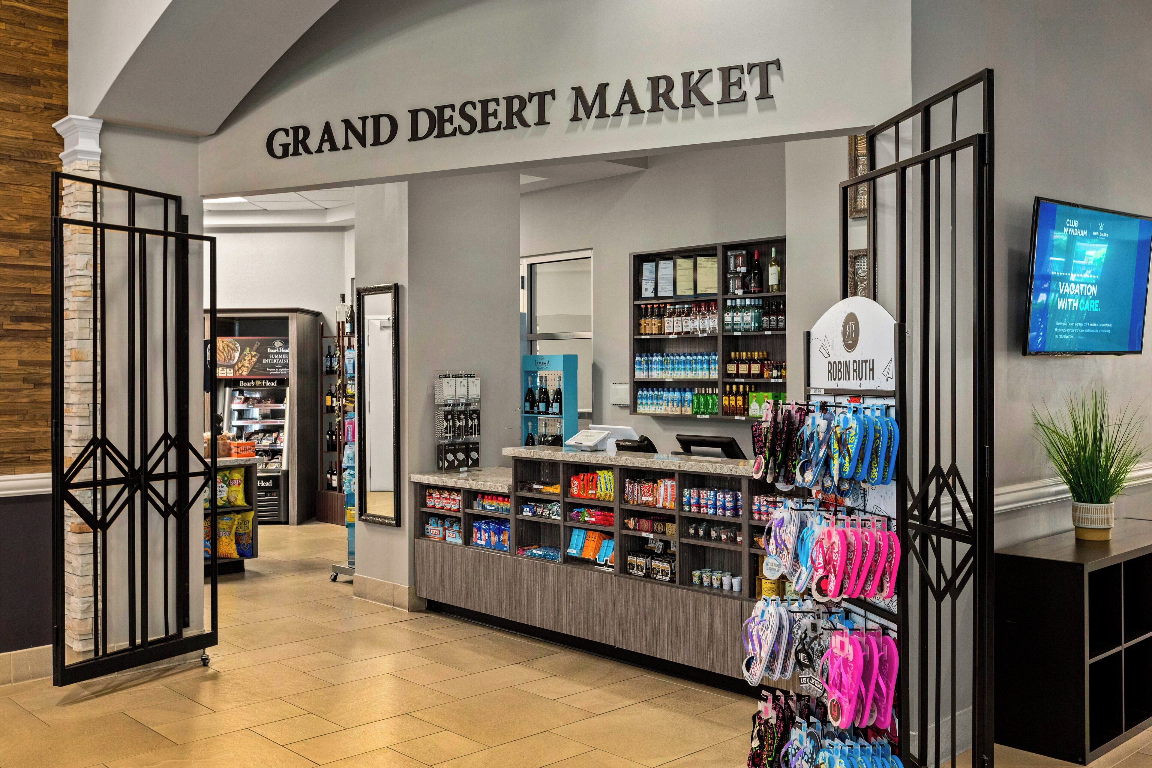 A Grand Desert Market with a variety of food items, a cash register, and a display of colorful bags.