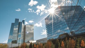 A modern building with reflective glass facades and a clear sky. - Mohegan Sun (Montville)