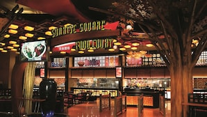 A restaurant with a sign reading "Gourmet Square Food Court" and a large tree sculpture in the center. - Mohegan Sun (Montville)