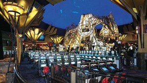 A casino interior with a large, illuminated gaming area and a distinctive ceiling structure. - Mohegan Sun (Montville)