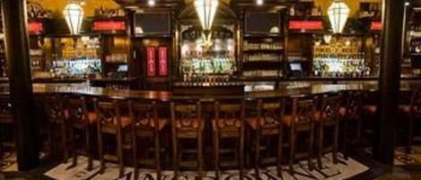 A bar area with a circular seating arrangement and a sign that reads "LANSDOWN."