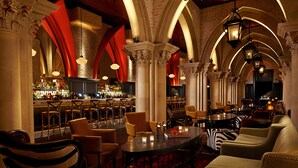 A bar area with seating, including zebra-striped chairs and a round table with candles. - Mohegan Sun (Montville)