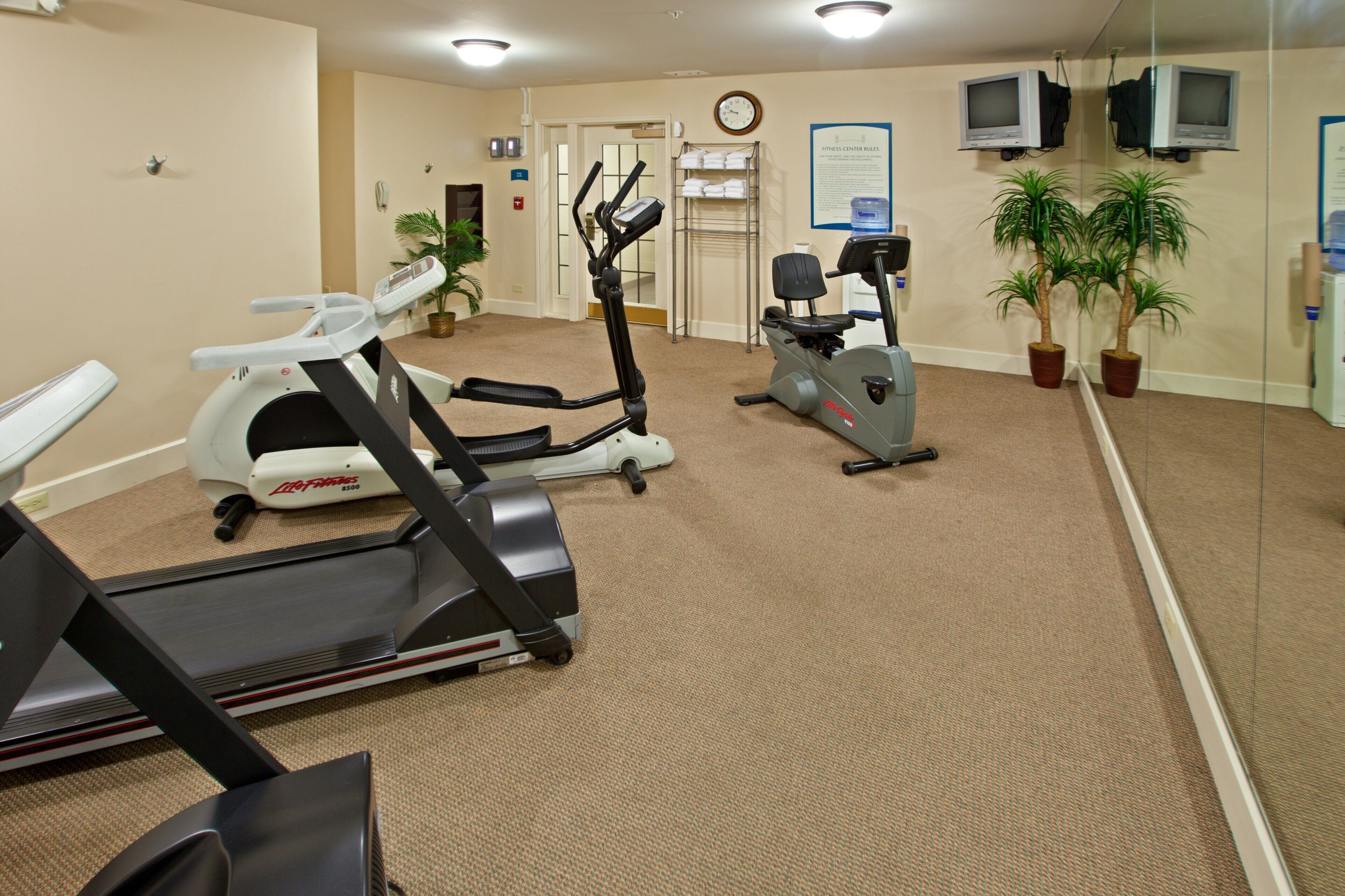 A fitness center with treadmills, an elliptical, and stationary bikes.