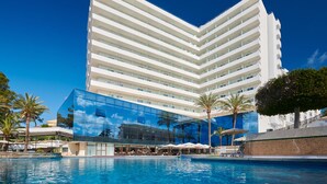 A modern hotel with a large pool area, outdoor seating, and palm trees. - Grupotel Taurus Park (Palma de Mallorca)