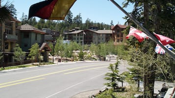 A hotel with a prominent flag, a road, and surrounding trees.