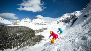 A snowy mountain landscape with skiers.