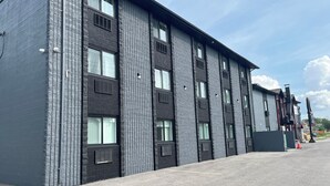A modern building with a brick facade, large windows, and a flat roof. - Mammas Inn (Niagara Falls)